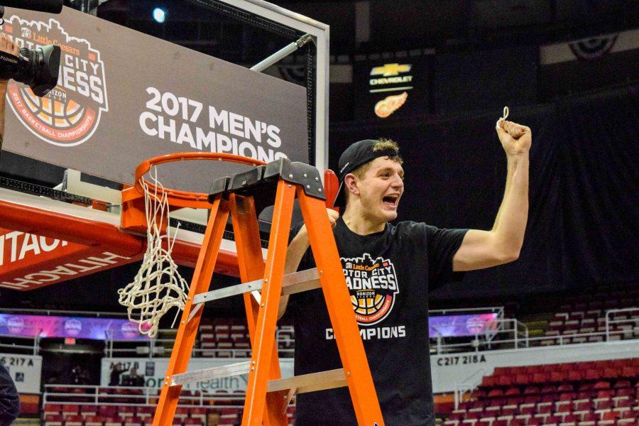 Drew McDonald celebrates after cutting down a portion of the net Tuesday night.