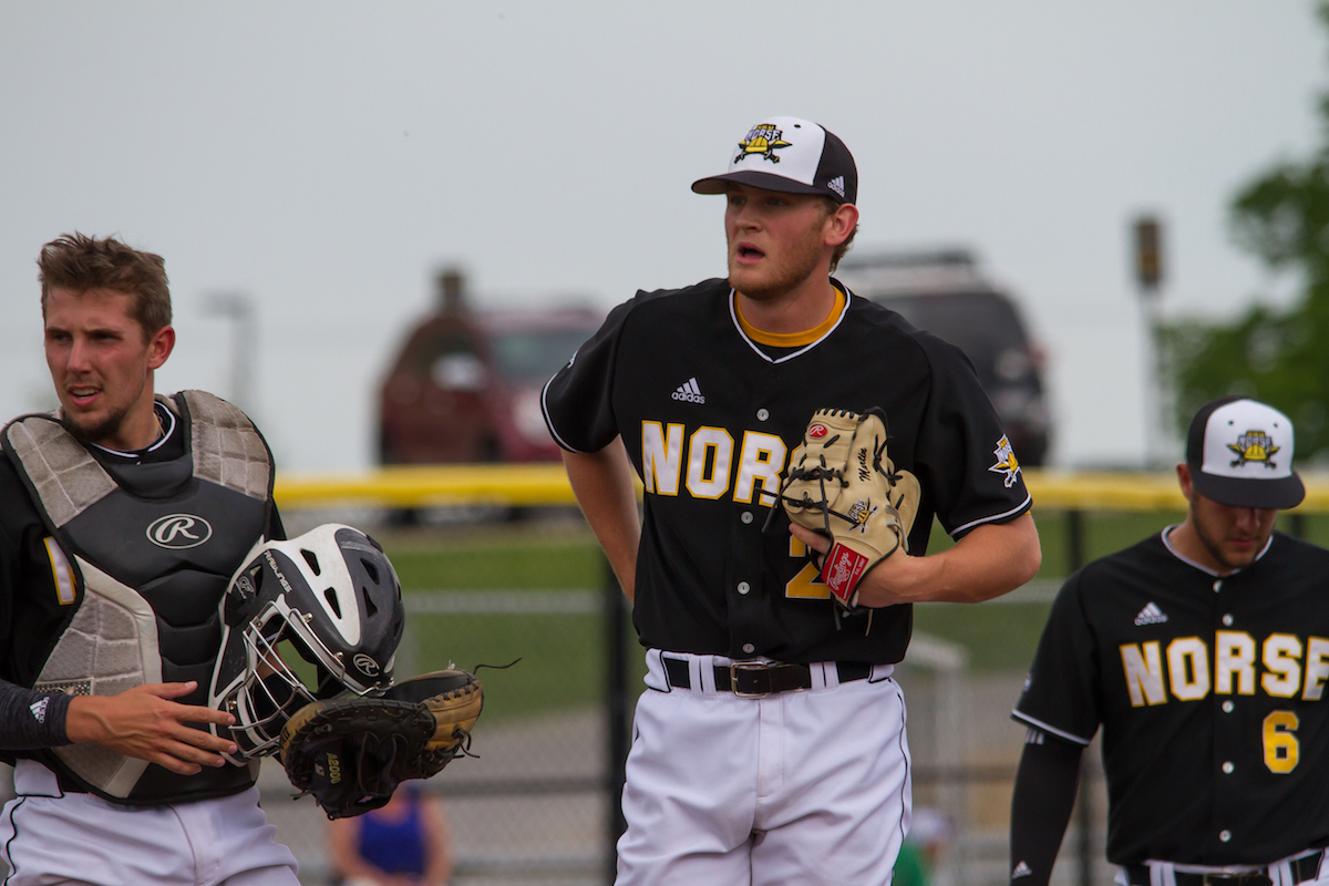 Norse players gather on the mound during Friday's game against Wright State