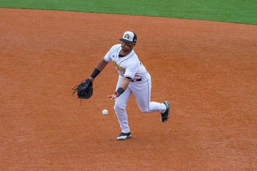 Trey Ganns underhands a ball to the pitcher covering first base.