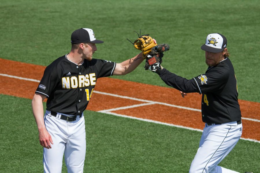 Cameron Ross (14) and Dominic Mercurio (4) slap gloves after an inning. Ross didnt allow a run in 2.2 innings of work