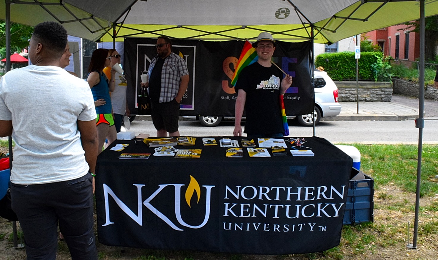 Noah Pittinger handed out resources at NKU's booth. Rainbow flag in hand, he hope everyone can one day be themselves. 