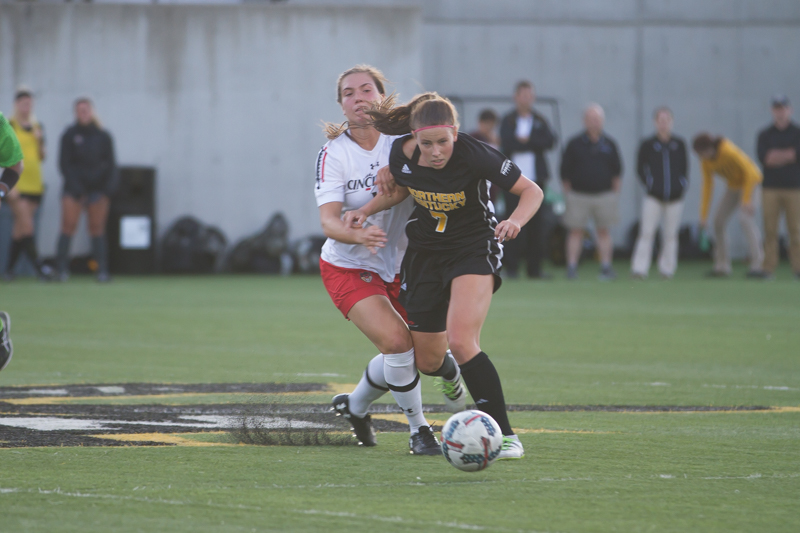 Emily Soltes (7) Fights to dribble past a UC defender