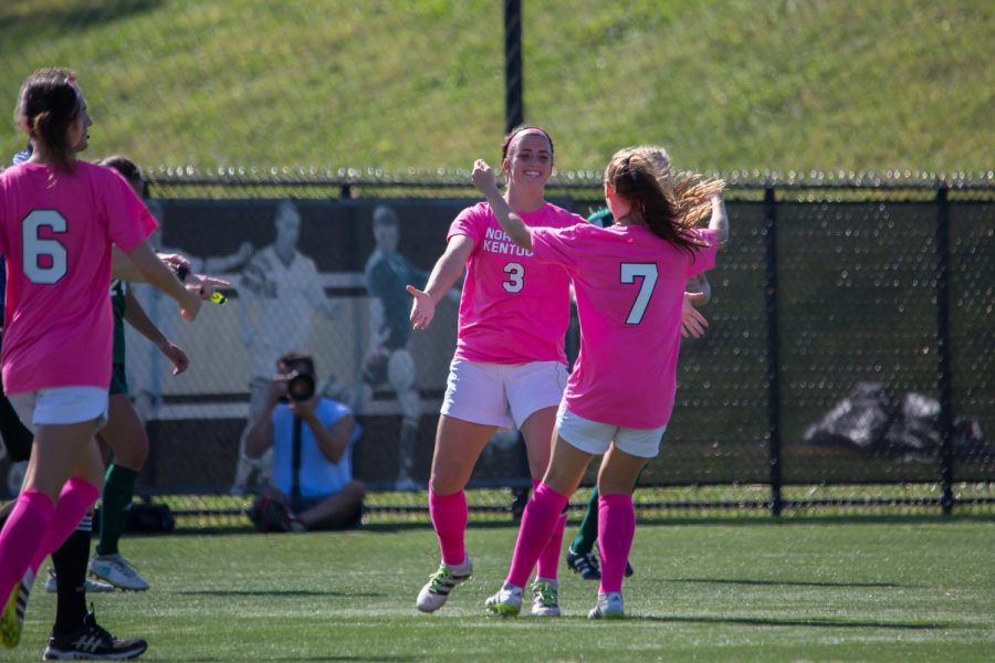 Macy Hamblin (3) and Emily Soltes (7) celebreate after a goal in the game against Green Bay