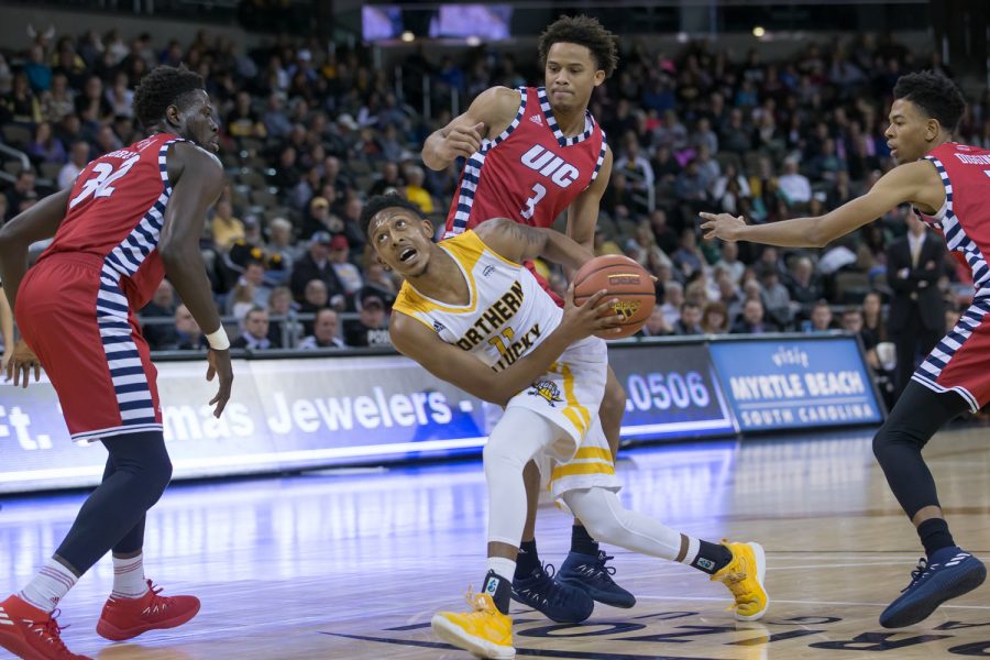 Mason Faulkner (11) fights to shoot in the game against UIC.