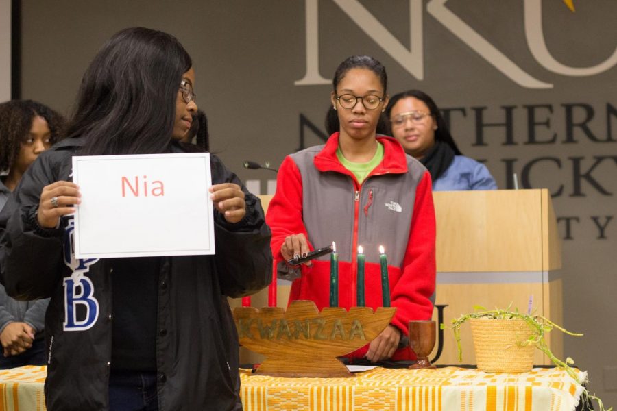 As the principles of Kwanzaa are announced a the candle that represents it is lit.
