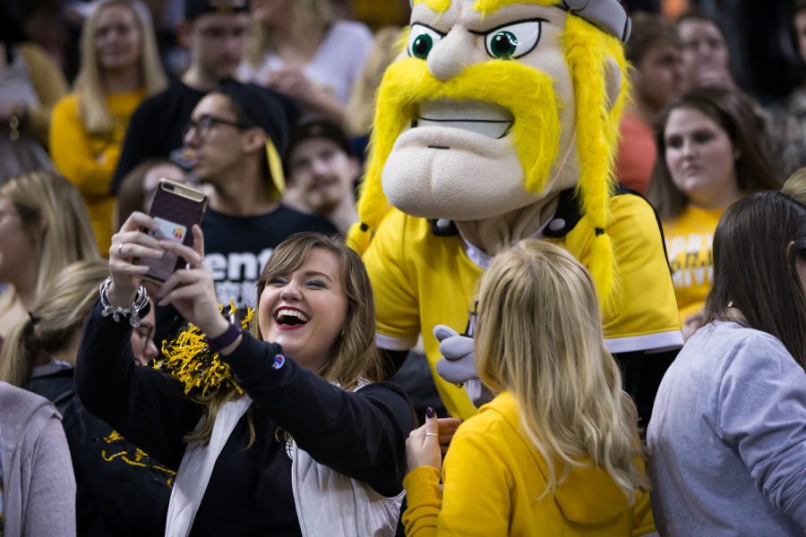 An NKU fan takes a photo with Victor.
