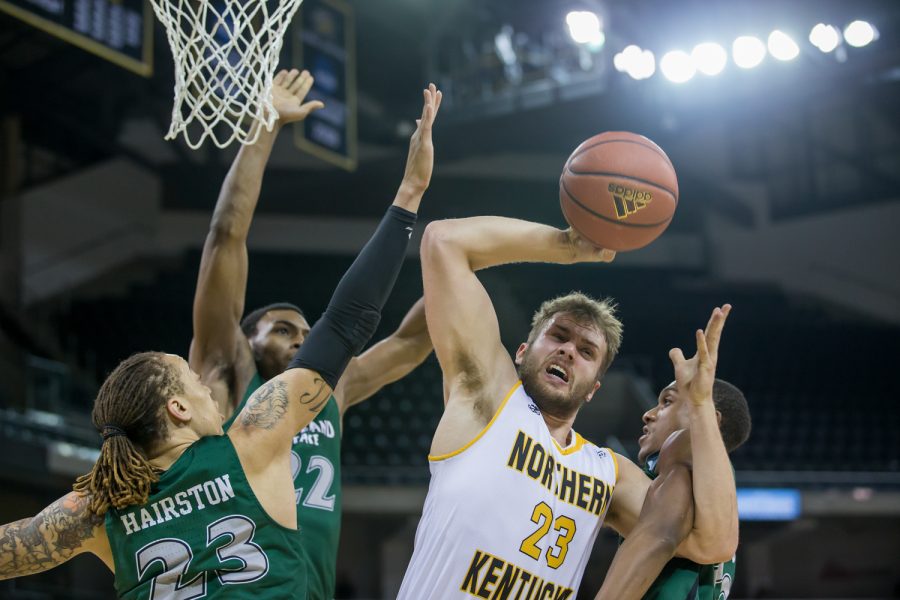 Carson Williams (23) fights to shoot under pressure in the game against Cleveland State.