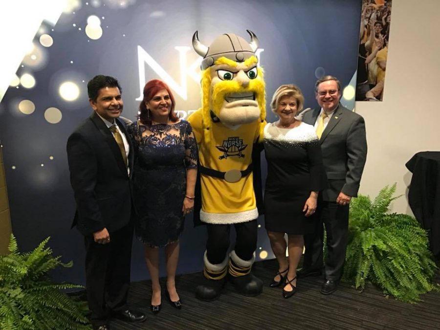 The interim and incoming president pose with Victor E. Viking before the Alumni Association Awards. 