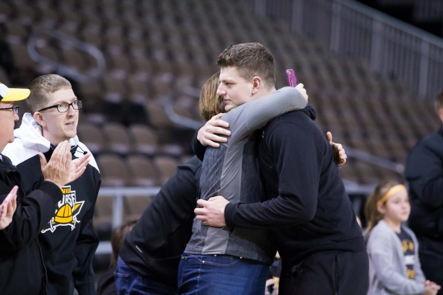 Drew McDonald (34) hugs his mother before the net cutting in BB&T Arena after securing 1st place in Horizon League.