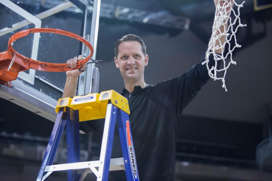 Head Coach John Brannen holds up the net to the spectators in BB&T Arena.