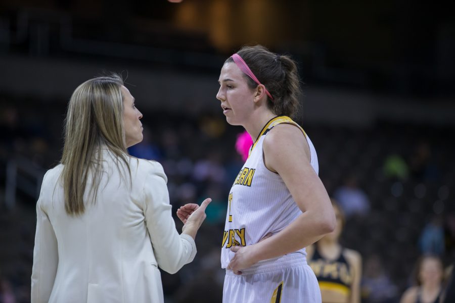 Head Coach Camryn Whitaker talks to Grayson Rose (10) during a timeout in the game against Oakland.