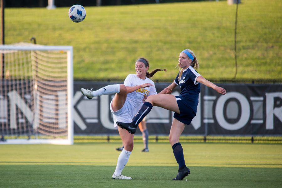 Erin Sutton (2) reaches to get a touch on a high ball.