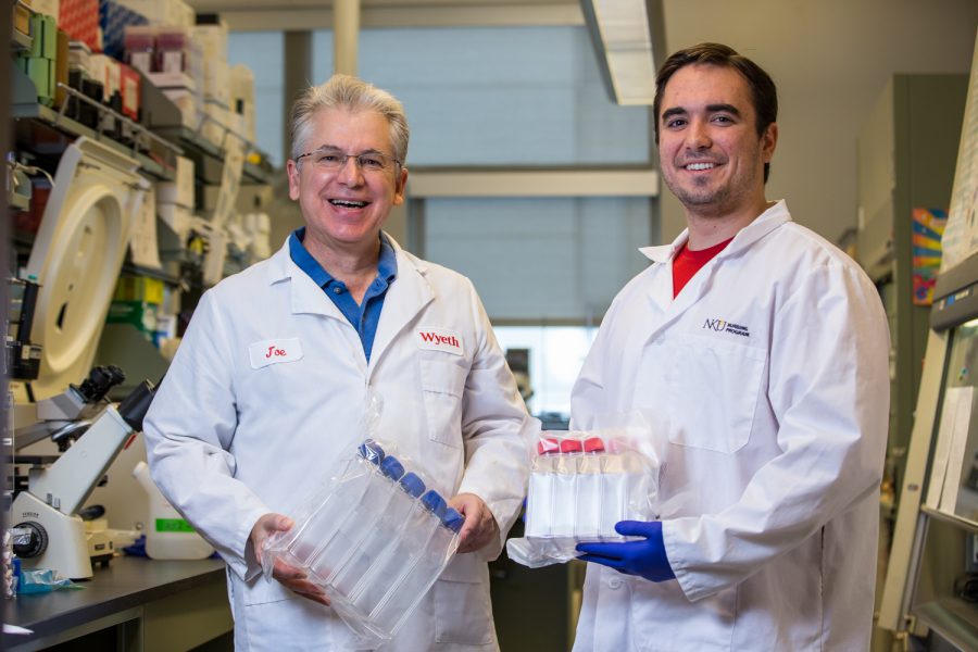 Dr. Joseph Mester and Brett Messmer working on the hepatitis C vaccine. 