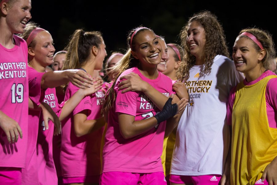 Samantha Duwel (27) celebrates with teammates after her golden goal during the second overtime period. Her goal pushed the Norse past Detroit Mercy.