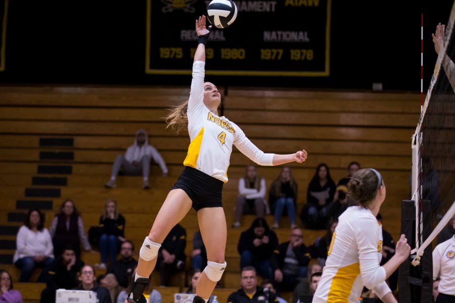 Haley Libs (4) jumps to hit a ball during the game against Oakland. Libs had 14 kills during the game.