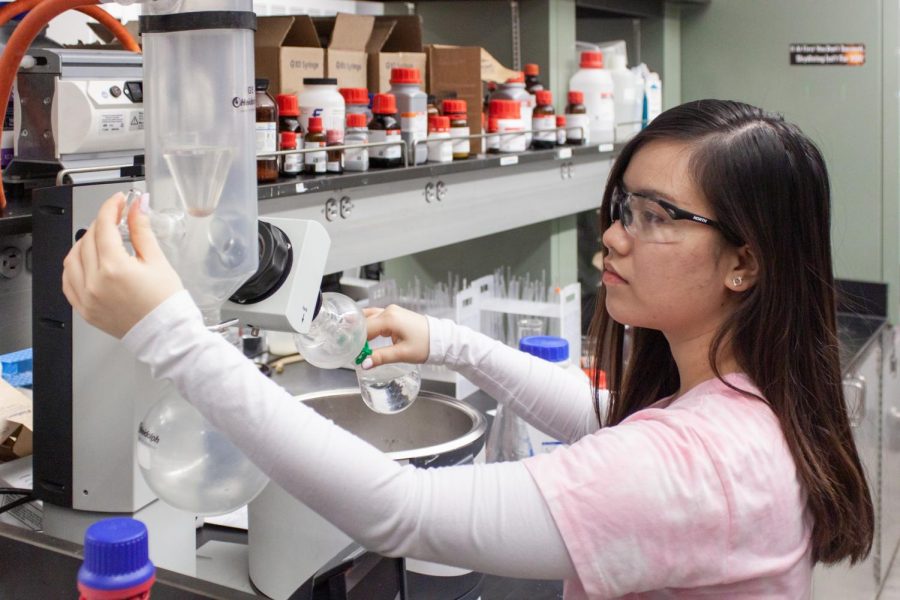 Quynh Nguyen works in a lab inside the science center.