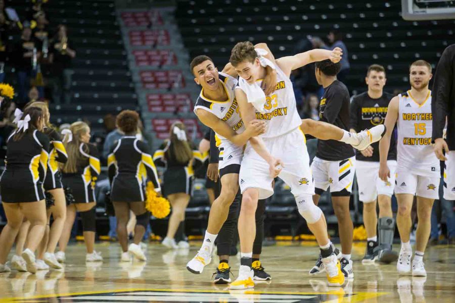 Paul Djoko (2) congratulates Chris Vogt (33) on his performance during the game against Green Bay. Vogt lead the team in scoring with 20 points.