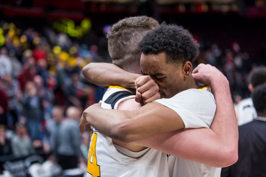 Jalen Tate (11) hugs Drew McDonald (34) after his game winning three point shot during the semi-final game of the Horizon League Tournament. The ball was inbounded with 9 seconds on the clock.