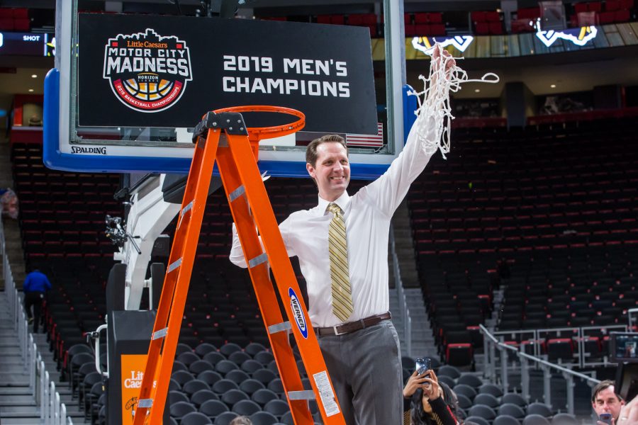 Men's Basketball Head Coach John Brannen holds up the net following the final game of the Horizon League Tournament. The Norse defeated Wright State 77-66.