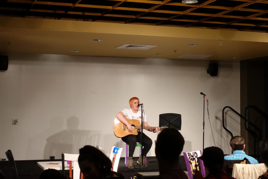 A student shares an original song at the 6th annual Open Mic Night.