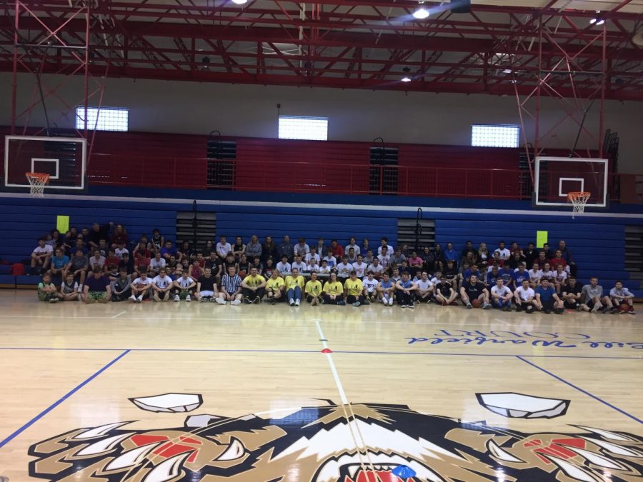 A group of volunteers and students gather for a group photo at Conner High School.