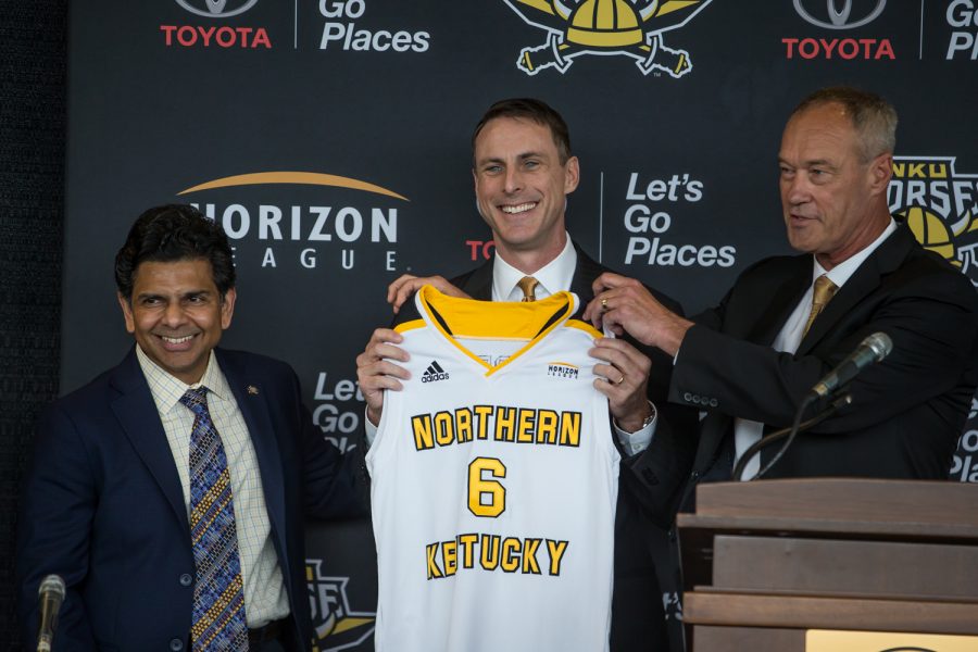 NKU President Ashish Vaidya (left) and Ken Bothof (right)stand alongside newly introduced Mens Basketball Head Coach Darrin Horn.