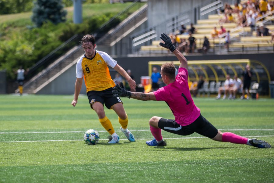 Alex Willis (9) fights to shoot during Sundays Exhibition match against Tiffin. Willis had 2 goals on the game against Tiffin.