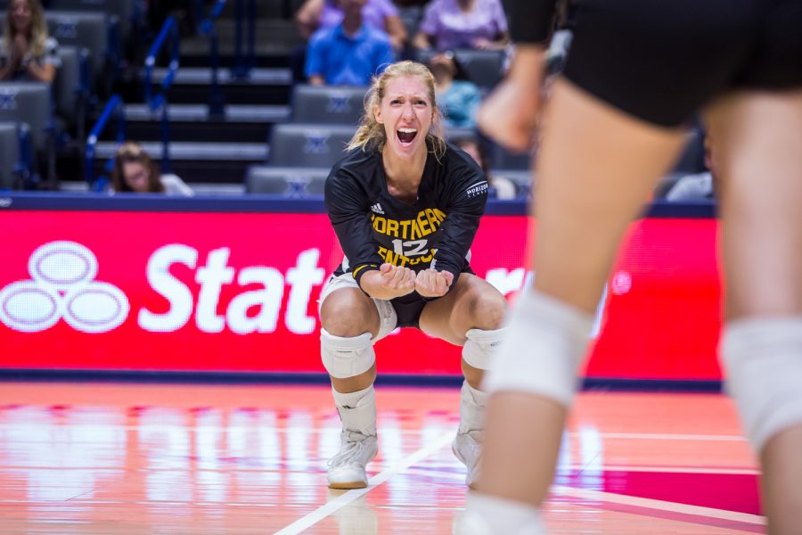 Laura Crawford (12) cheers after a point for the Norse during the game against Xavier. The Norse won 3 of 4 sets on the game and defeated Xavier.