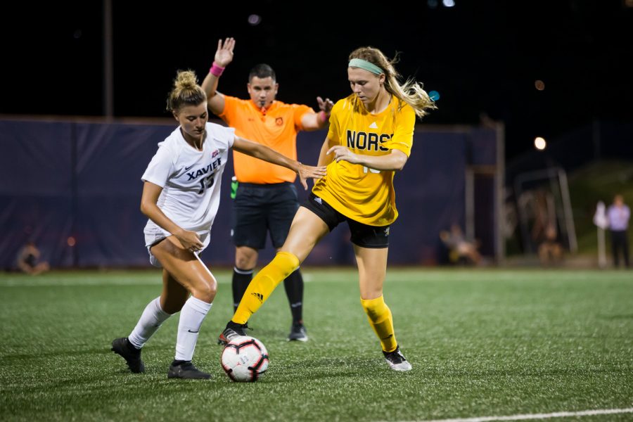 Kailey Ivins (15) fights to keep possession of the ball during Thursdays  match against the Musketeers. The Norse fell to Xavier 4-0.