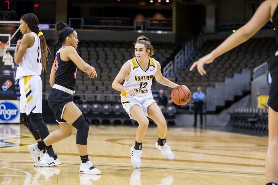 Carissa Garcia (12)  looks to pass during the game against Davis & Elkins College. Garcia shot 7-of-16 and had 16 points on the night.