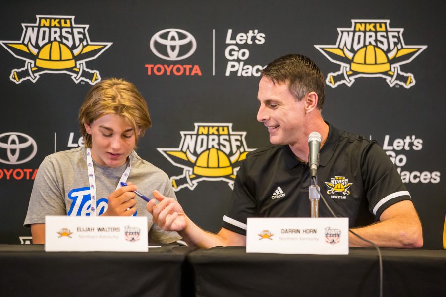 Elijah Walters signs his letter of intent with NKU mens basketball head coach Darrin Horn.