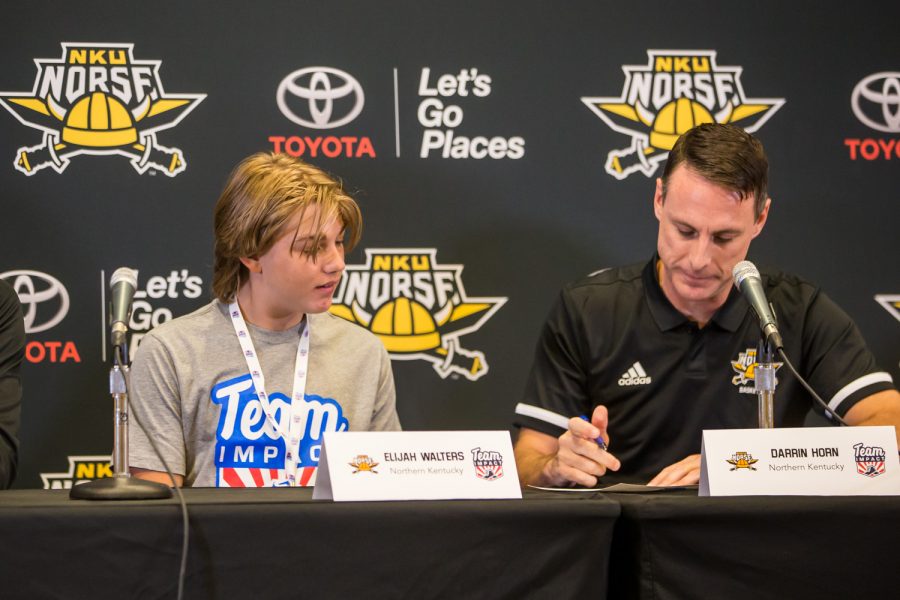 Coach Horn signs Elijah's letter of intent.