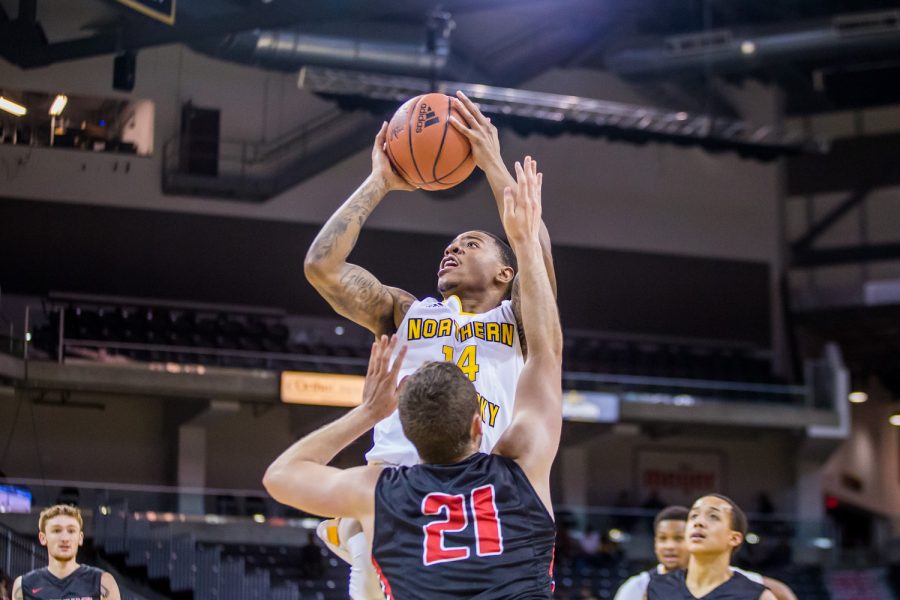 Karl Harris (14) fights to get a shot off during the game against UC Clermont. Harris shot 5-of-6 on the night and had 16 points.