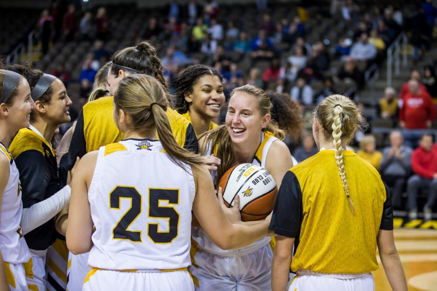 Molly Glick (24) celebrates with her teammates after receiving her ball from Womens Basketball Head Coach Camryn Whitaker for accumulating the 1000 career points.