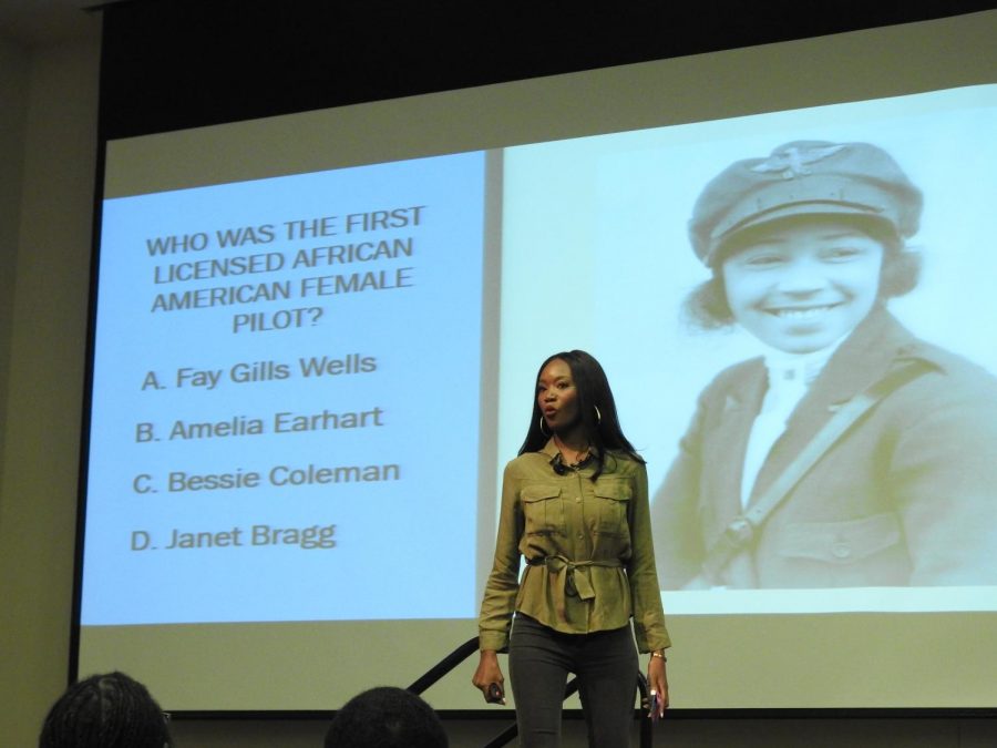 Deshauna Barber reads a trivia question aloud to the audience.