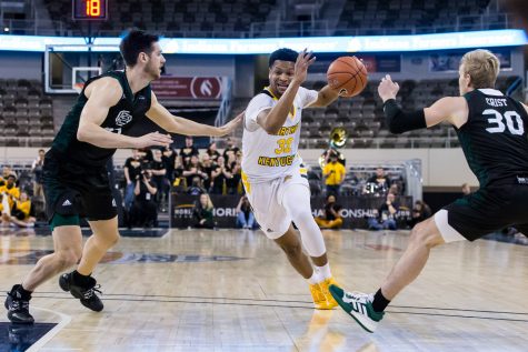 Dantez Walton (32) drives between two Green Bay players during the Semi-Final game of the Horizon League Tournament against Green Bay. The Norse defeated Green Bay 80-69 and move on the face UIC in the final round of the Horizon League Tournament.