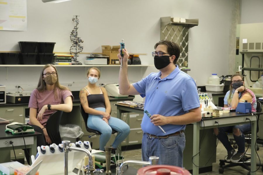 Assistant+Professor+Brian+Carlson+goes+over+a+mock+pipette+demonstration+with+the+class.