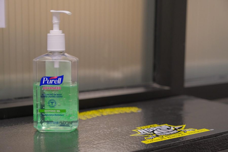 Hand sanitizer on a table outside Health, Counseling & Student Wellness in University Center 440.