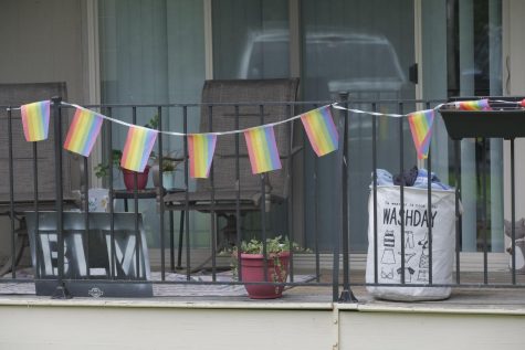 A white laundry basket sits on a patio.