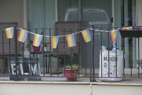 A white laundry basket sits on a patio. 