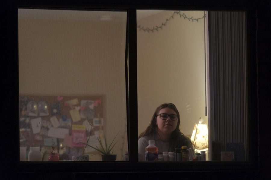 Sleczkowski sits in her apartment. She stares out through the window.