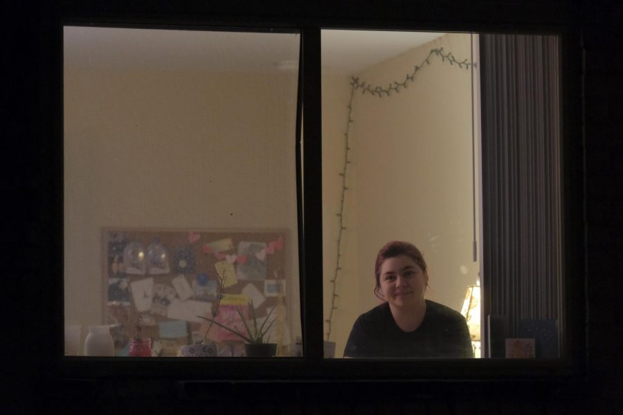 Kaeppner sits inside her apartment and looks at through the window.