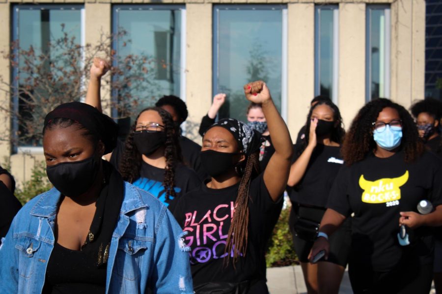 Students hold their fists up in protest.