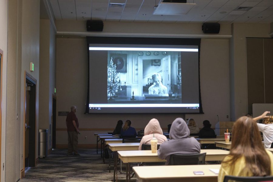 Socially distanced students watch a movie in the Student Union ballroom. 