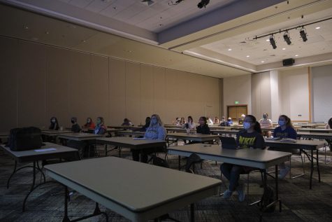 Socially distanced students watch a movie in the Student Union ballroom.