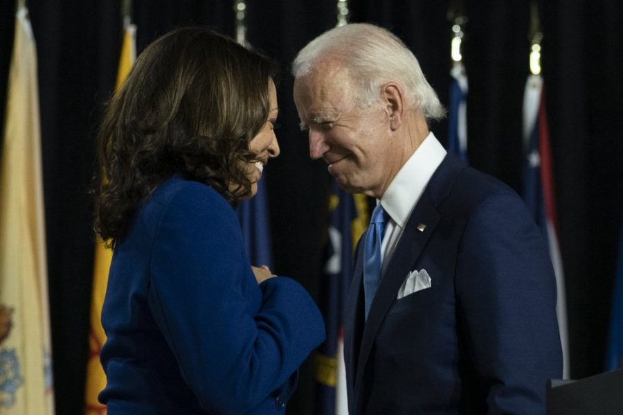 In this Aug. 12, 2020, Democratic presidential candidate former Vice President Joe Biden and his running mate Sen. Kamala Harris, D-Calif., pass each other as Harris moves to the podium to speak during a campaign event.