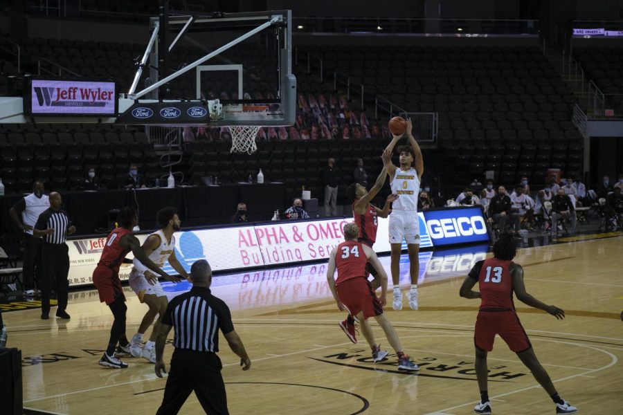 Freshman Trey Robinson (0) shoots over a defender. Robinson finished with 11 points on the game.