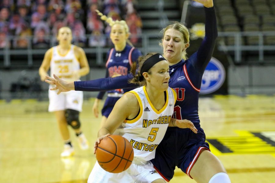 Guard Lindsey Duvall (5) drives to the hoop against a Robert Morris defender. Duvall finished the game with 21 points and 13 rebounds.