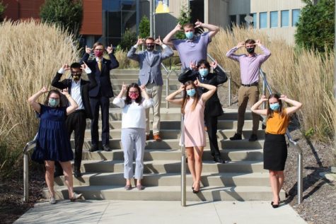SGA members "Norse Up" outside while wearing masks. 