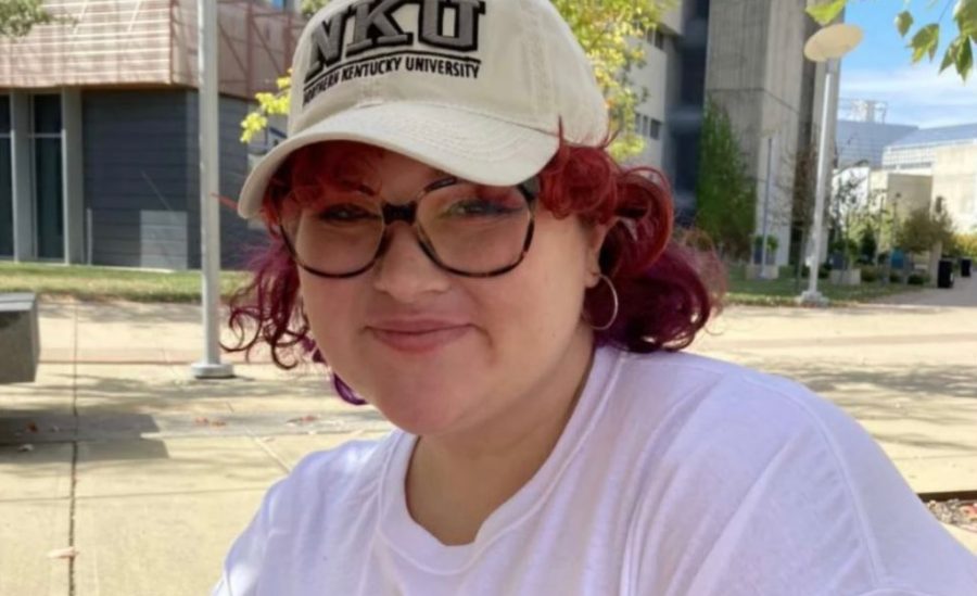 Katherine Carter with pink hair and a baseball cap.